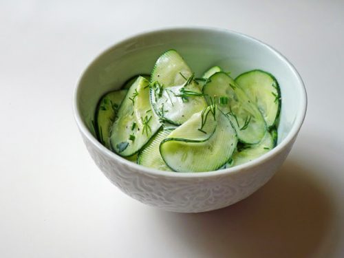 Bowl of sliced cucumber salad with Bragg Apple Cider Vinegar